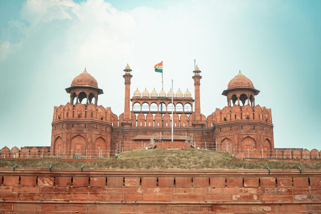 Front view of the historic Red Fort in New Delhi, featuring its iconic architecture and Indian flag.